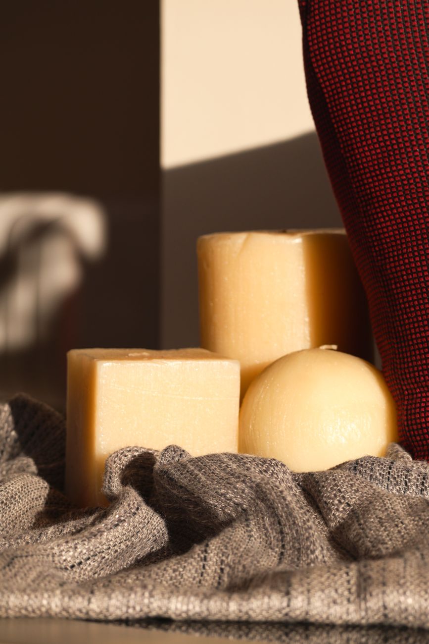Warm and inviting candle setup on textured fabric, perfect for home decor inspiration.